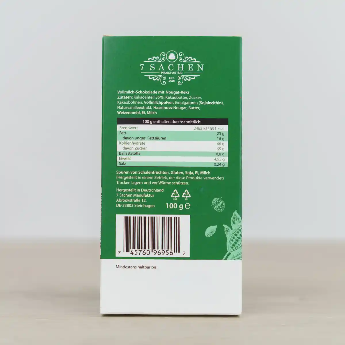 Handgegossene Vollmilchschokolade mit Nougat & Butterkeks – zart & knusprig, aus Valrhona-Couverture, handgefertigt in Steinhagen. Rückseite