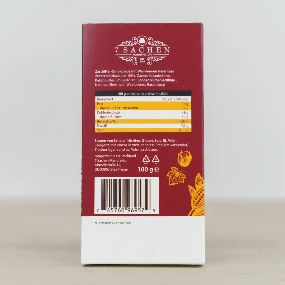 Handgegossene Zartbitterschokolade 55 % mit Haselnuss und Weinbeeren – fruchtig & nussig aus Steinhagen. Rückseite